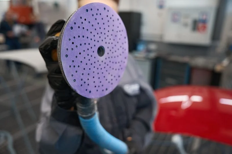 Film sanding discs with polyester backing for controlled finishing
