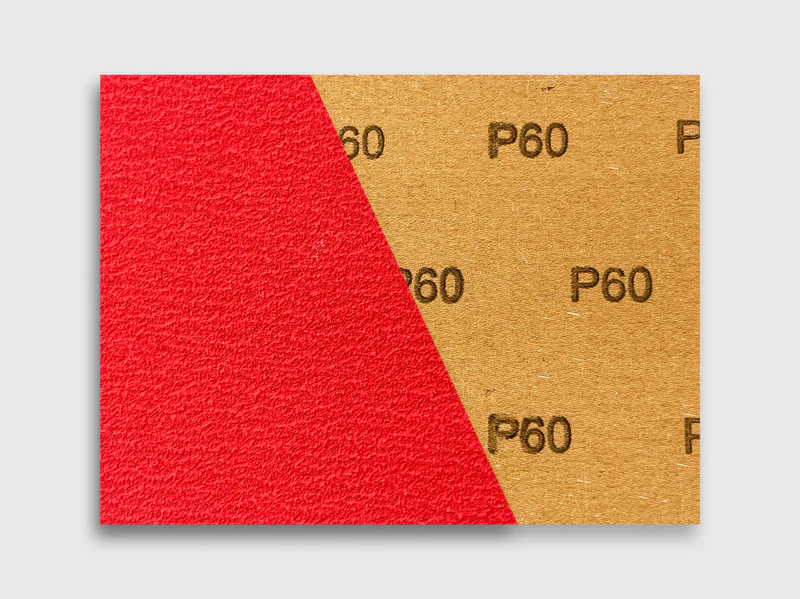 Close-up product image of red ceramic sanding disc P60 grit, industrial grade abrasive, e-commerce ready
