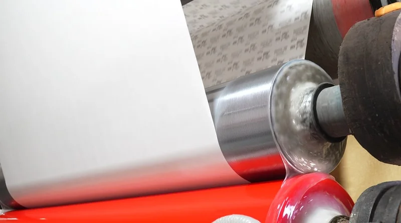 Roll formation and tension control during abrasive roll manufacturing