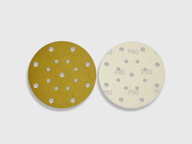 Brown aluminum oxide sanding discs P80 grit, multiple holes, white background e-commerce photo