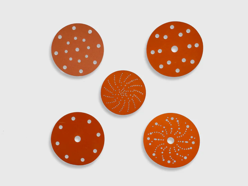 Orange ceramic sanding disc product image, various hole patterns, white background, industrial grade
