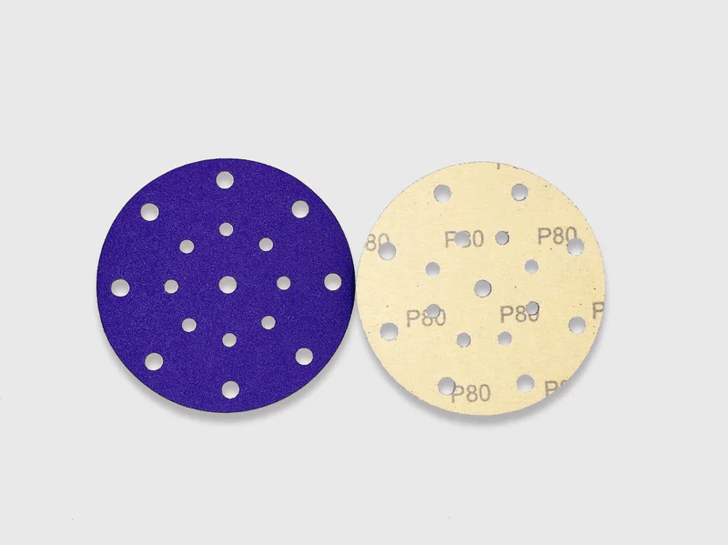 Purple and beige zirconia alumina sanding discs with multiple holes, e-commerce product image